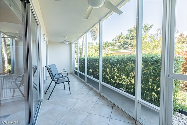 unfurnished sunroom featuring ceiling fan