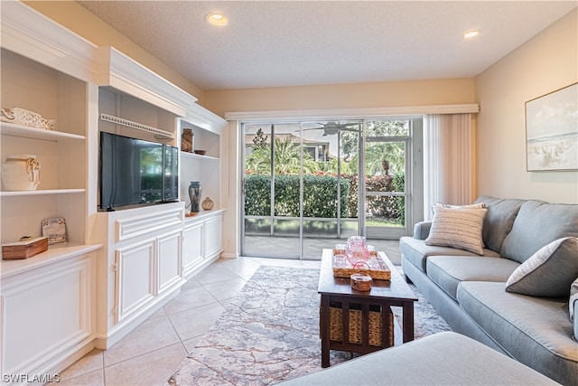 living room featuring built in features, a textured ceiling, light tile flooring, and ceiling fan