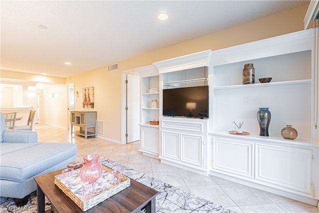 tiled living room featuring built in shelves