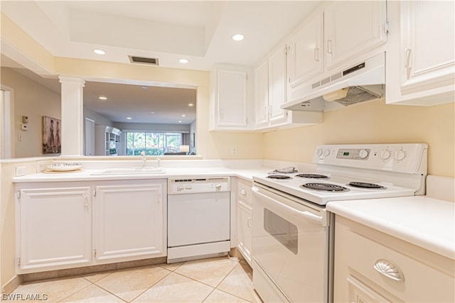 kitchen featuring white appliances, white cabinets, sink, and light tile floors