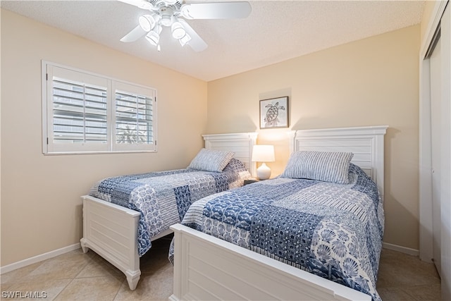 tiled bedroom featuring a textured ceiling, a closet, and ceiling fan