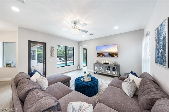 living room featuring ceiling fan and light hardwood / wood-style floors