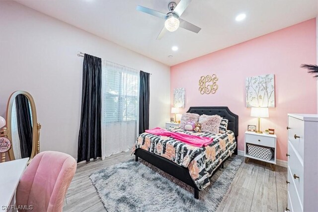 bedroom with light wood-type flooring and ceiling fan