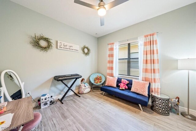 sitting room featuring ceiling fan and light hardwood / wood-style flooring