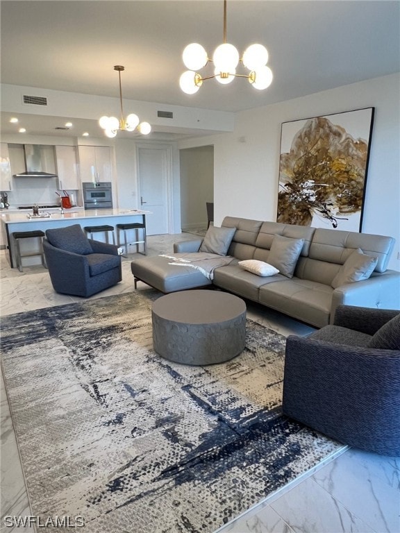 tiled living room with a notable chandelier