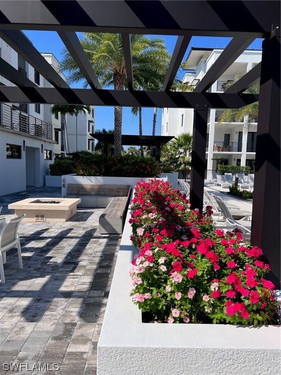 view of terrace with a pergola and a balcony