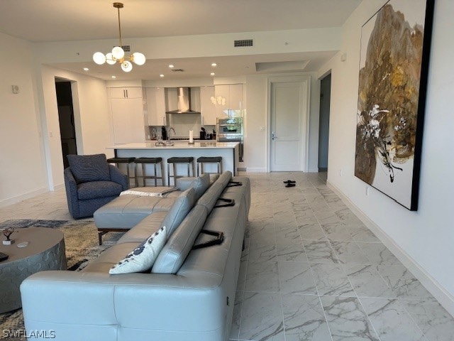 tiled living room featuring a chandelier