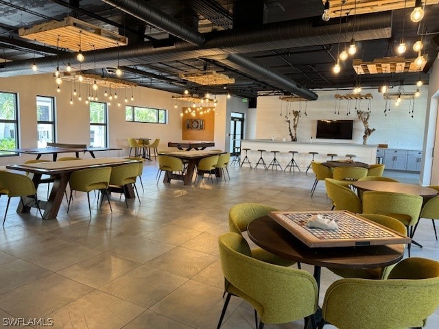 dining area with tile flooring and a chandelier