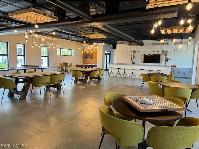 tiled dining area featuring a chandelier