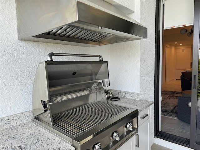 exterior details featuring wall chimney exhaust hood