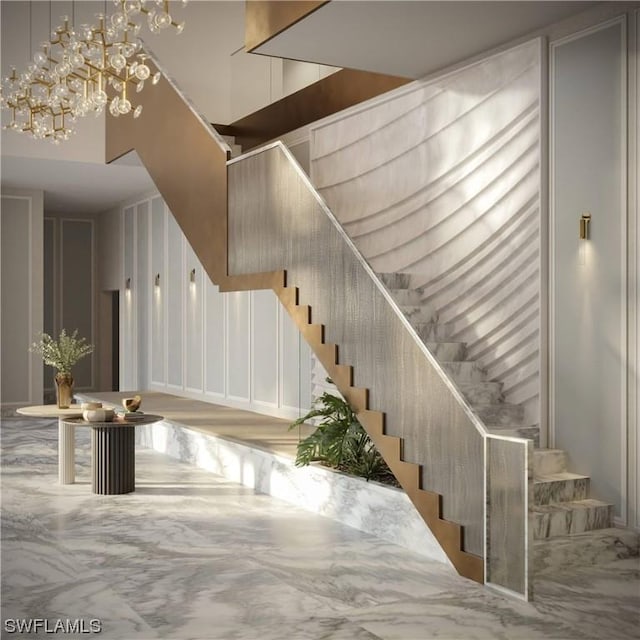 staircase featuring a towering ceiling and a notable chandelier