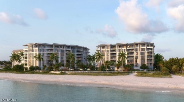 view of swimming pool featuring a water view and a beach view