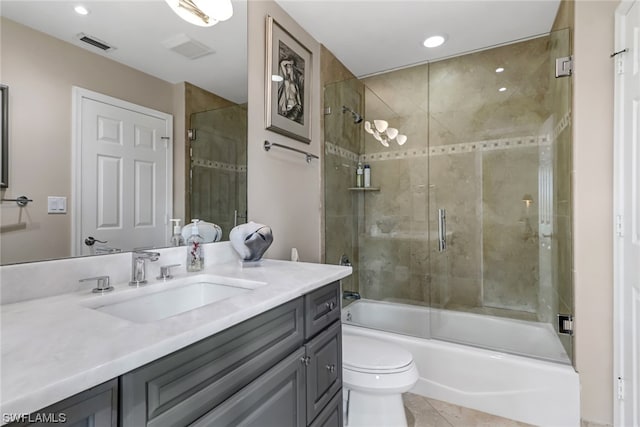 full bathroom featuring tile patterned floors, vanity, combined bath / shower with glass door, and toilet