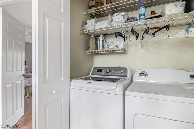 washroom featuring washing machine and dryer and tile patterned floors