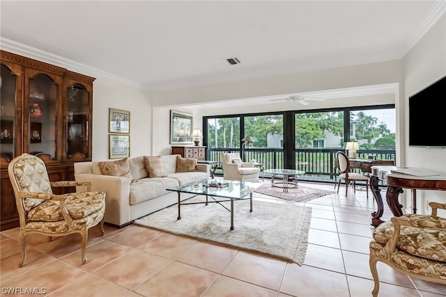 tiled living room with ceiling fan and crown molding