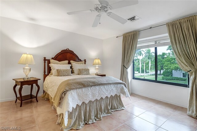 tiled bedroom with ceiling fan