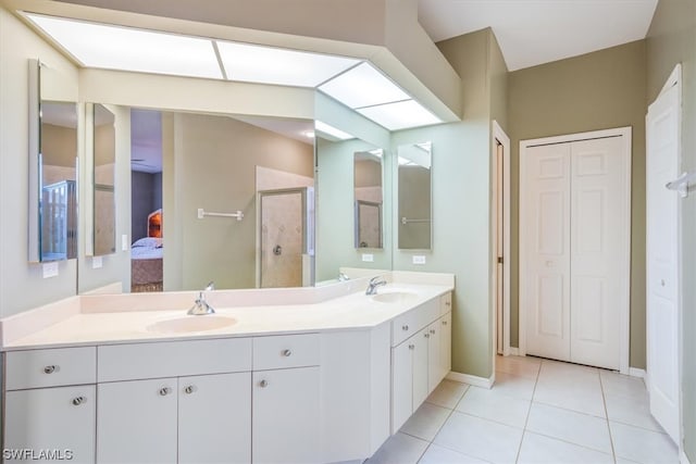 bathroom with tile floors and dual vanity