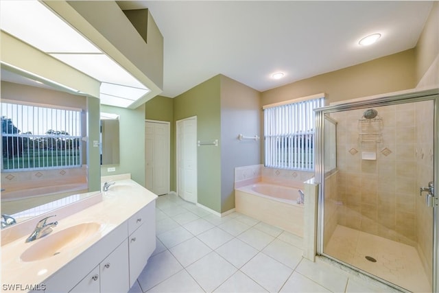 bathroom featuring shower with separate bathtub, tile floors, and large vanity