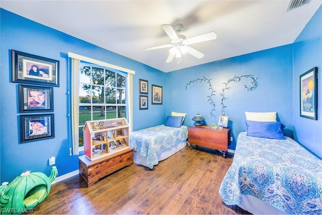 bedroom featuring ceiling fan and dark hardwood / wood-style flooring