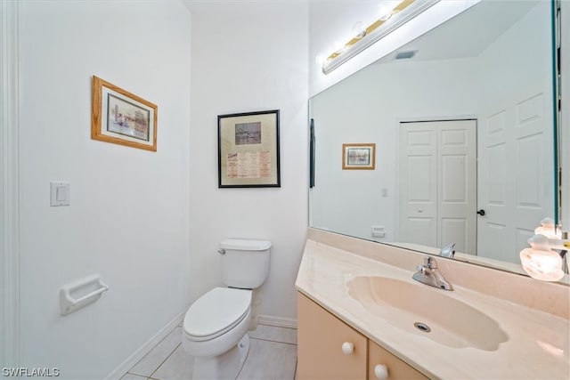 bathroom featuring toilet, large vanity, and tile flooring