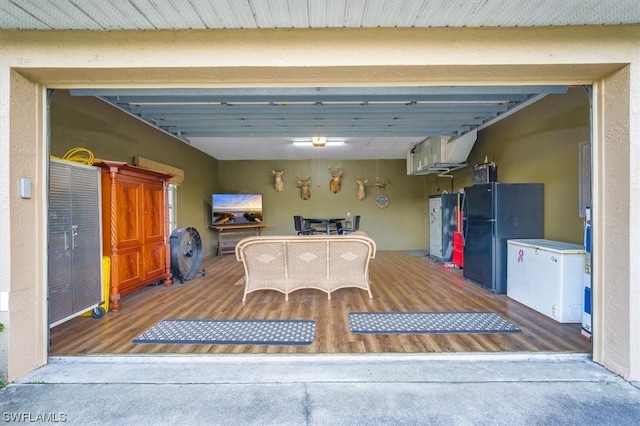 garage featuring black refrigerator and fridge