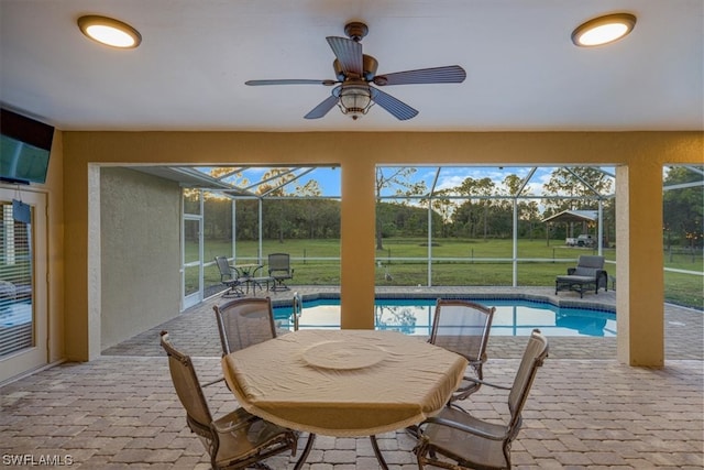 sunroom / solarium featuring ceiling fan