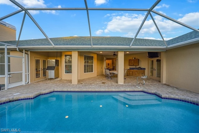 view of swimming pool featuring a patio area and a lanai