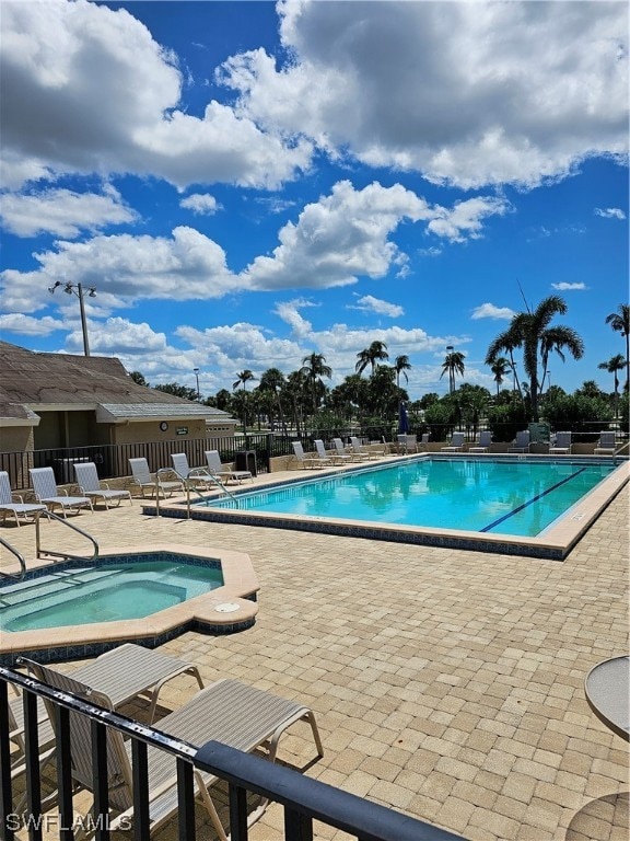 view of swimming pool with a patio and a community hot tub