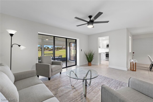 living room featuring light tile patterned floors and ceiling fan