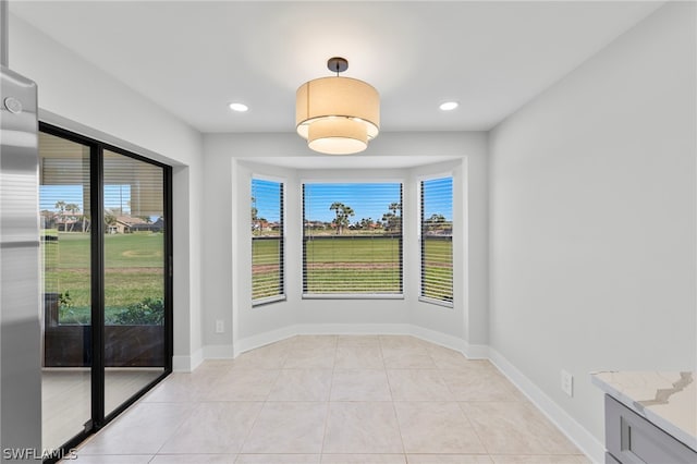 unfurnished room with light tile patterned floors