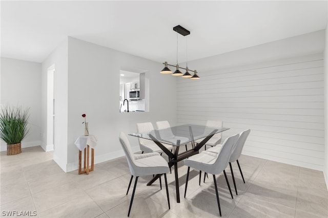 tiled dining area featuring sink