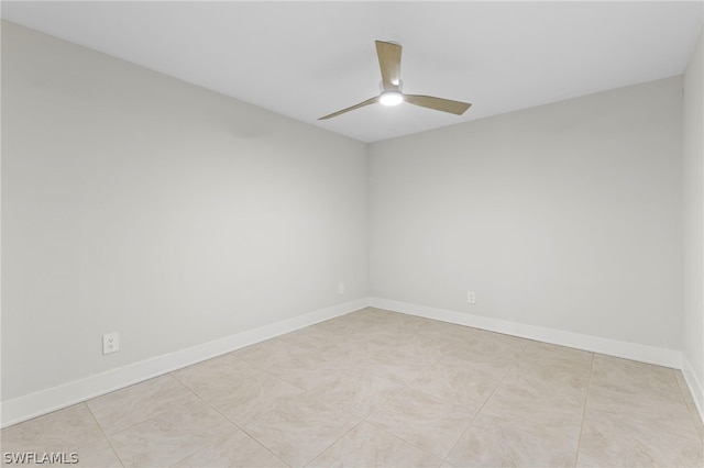 unfurnished room with ceiling fan and light tile patterned floors