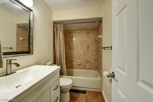 full bathroom with vanity, shower / bath combo, and toilet