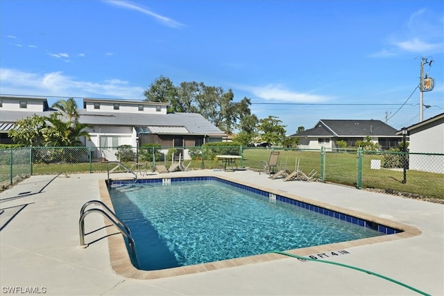 view of pool featuring a patio and a lawn