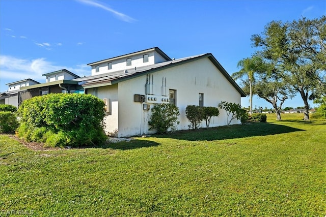 view of side of home featuring a lawn