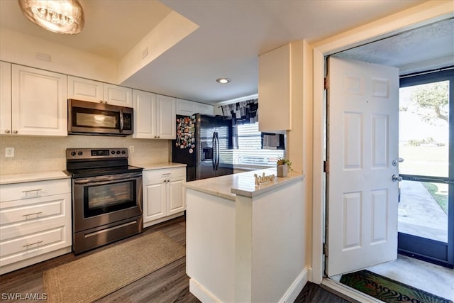 kitchen featuring stainless steel appliances, a wealth of natural light, and white cabinets