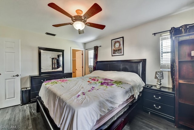 bedroom with dark hardwood / wood-style flooring and ceiling fan