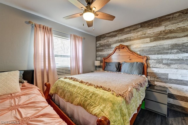 bedroom featuring dark hardwood / wood-style flooring, wooden walls, and ceiling fan