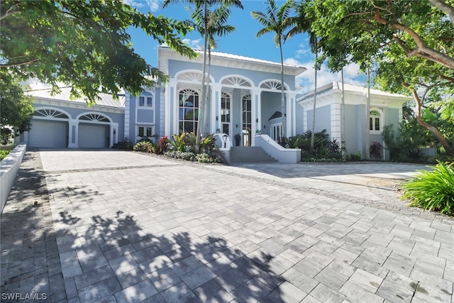 view of front of home with a garage and french doors