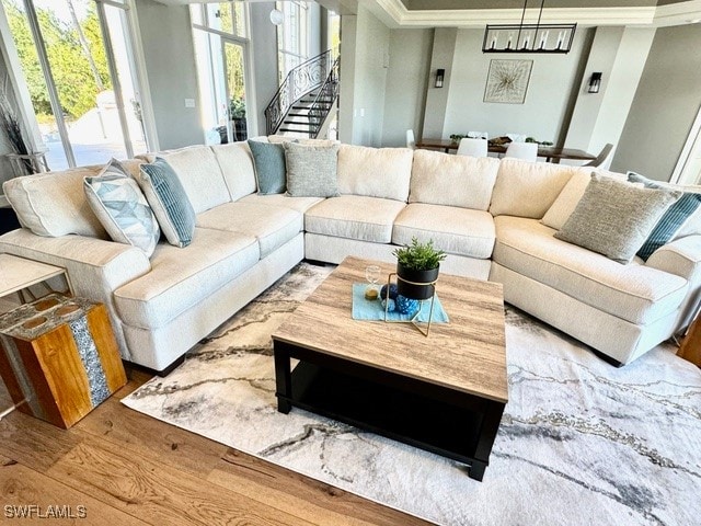 living room featuring crown molding and light hardwood / wood-style floors