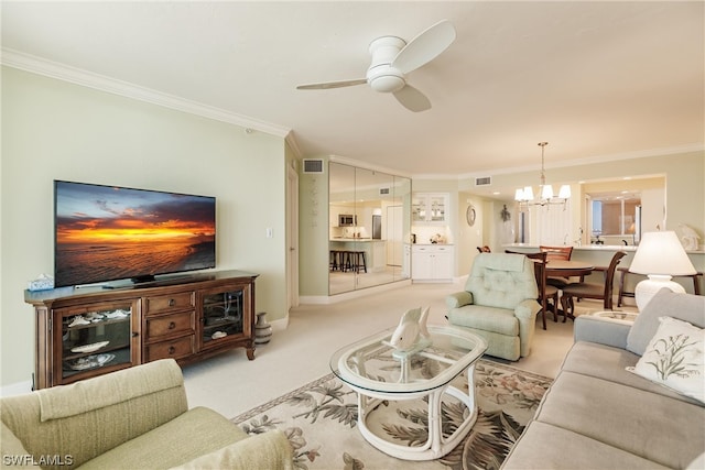 living room featuring light colored carpet, ornamental molding, and ceiling fan with notable chandelier