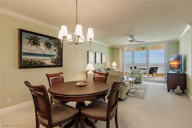 carpeted dining area featuring ornamental molding and ceiling fan with notable chandelier