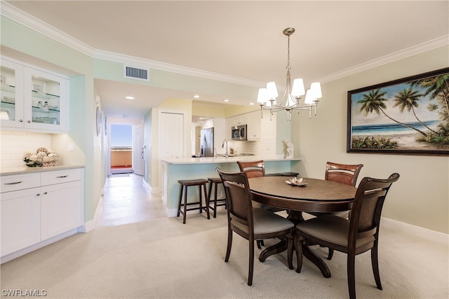 carpeted dining area with a notable chandelier and crown molding