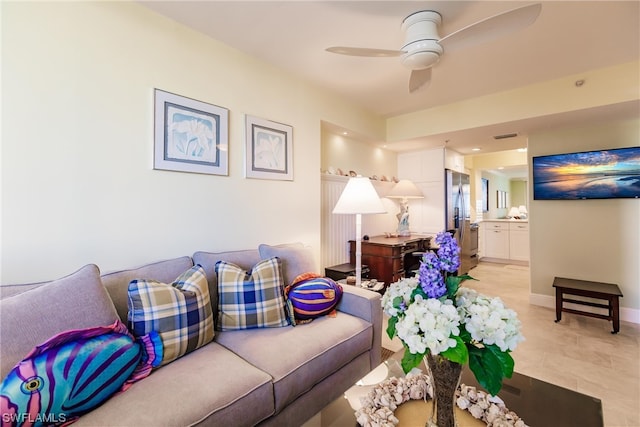 tiled living room featuring ceiling fan