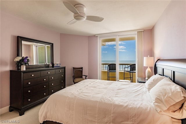 bedroom featuring a water view, access to exterior, ceiling fan, and light colored carpet