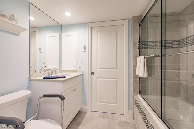 full bathroom featuring tile floors, combined bath / shower with glass door, toilet, and vanity