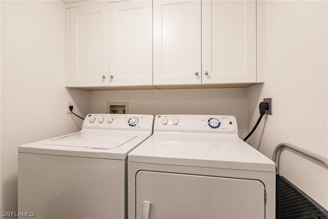 laundry area with electric dryer hookup, hookup for a washing machine, cabinets, and washer and clothes dryer