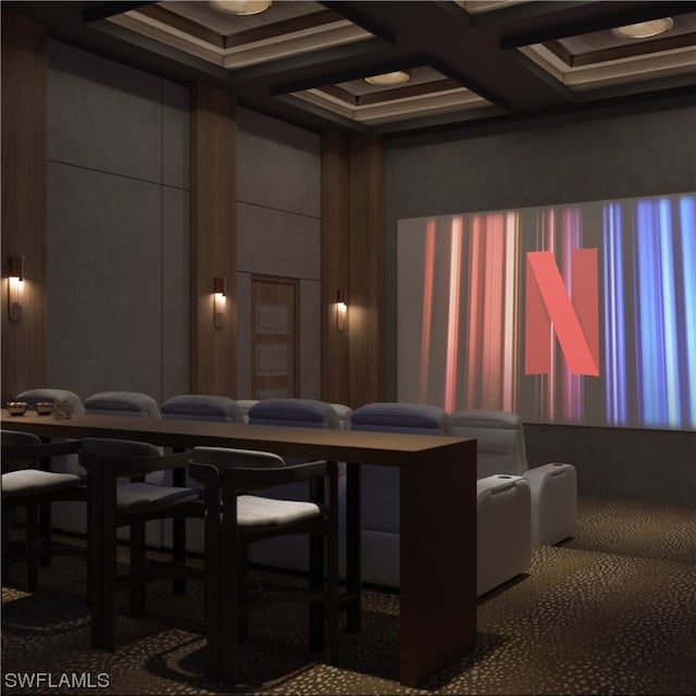 cinema room featuring coffered ceiling and dark carpet