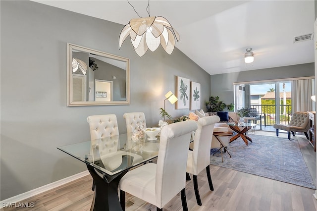 dining room with light wood-type flooring and lofted ceiling