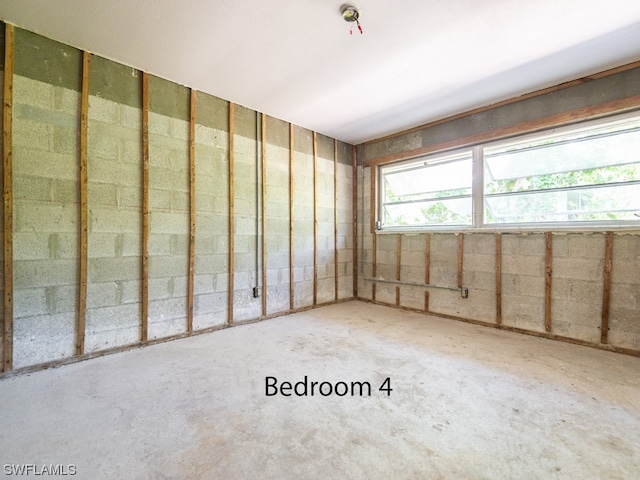 spare room with concrete floors